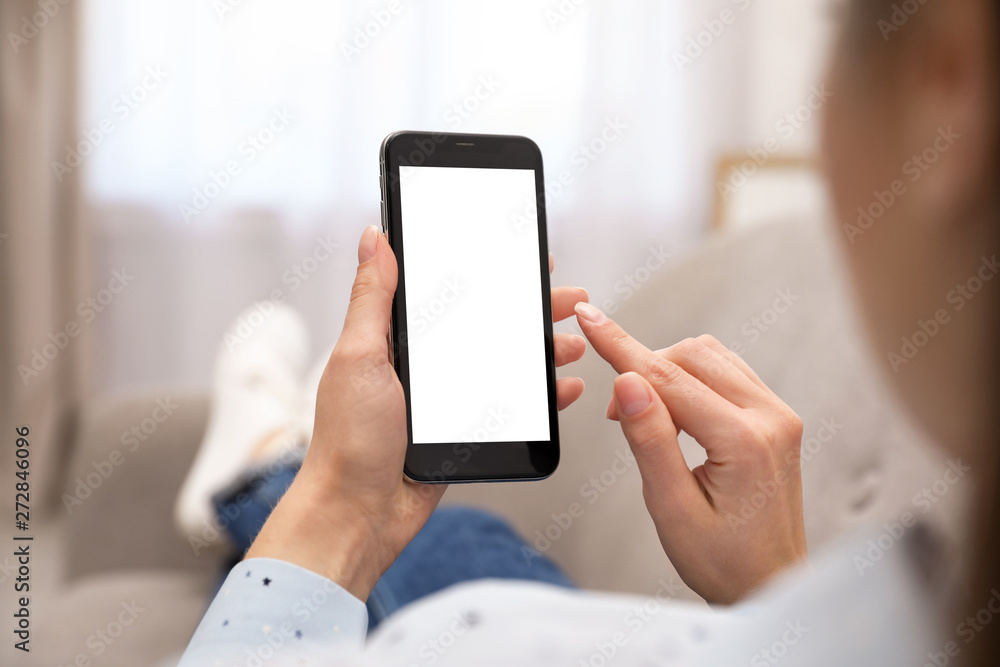 Woman holding smartphone with blank screen indoors, closeup of hands. Space for text Woman holding smartphone with blank screen indoors, closeup of hands. Space for text