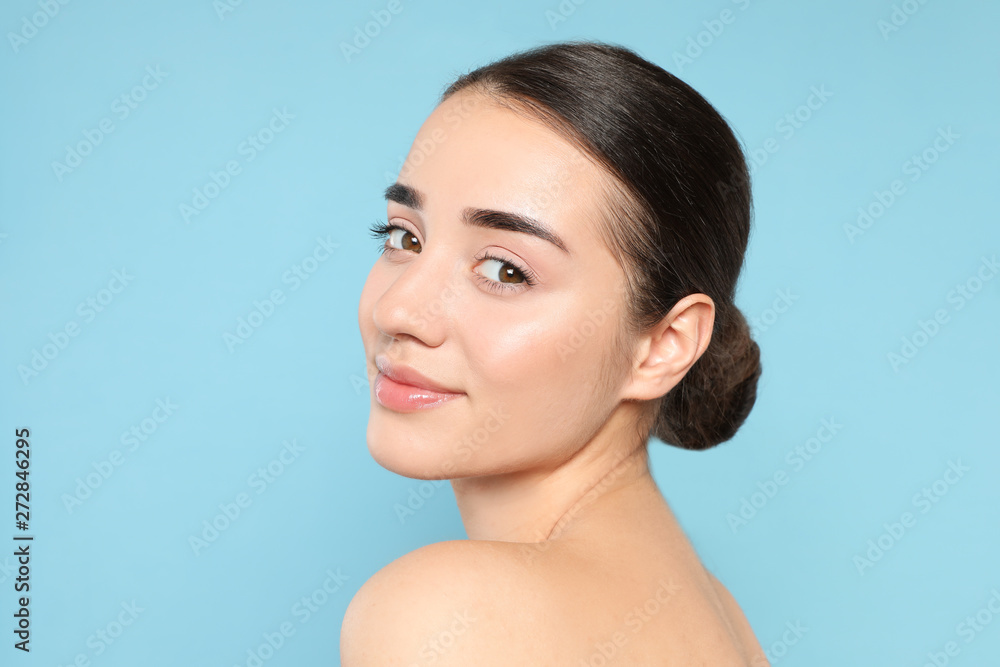 Portrait of young woman with beautiful face against color background Portrait of young woman with beautiful face against color background