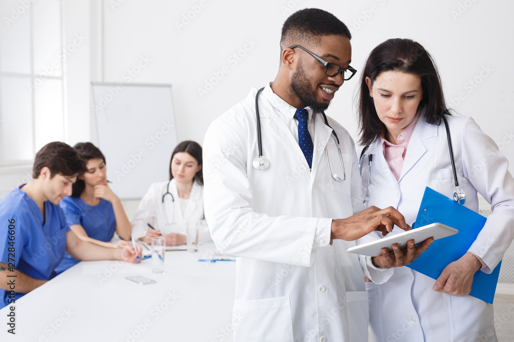 Doctor Giving His Colleague Piece Of Advice during Meeting Doctor Giving His Colleague Piece Of Advice during Meeting