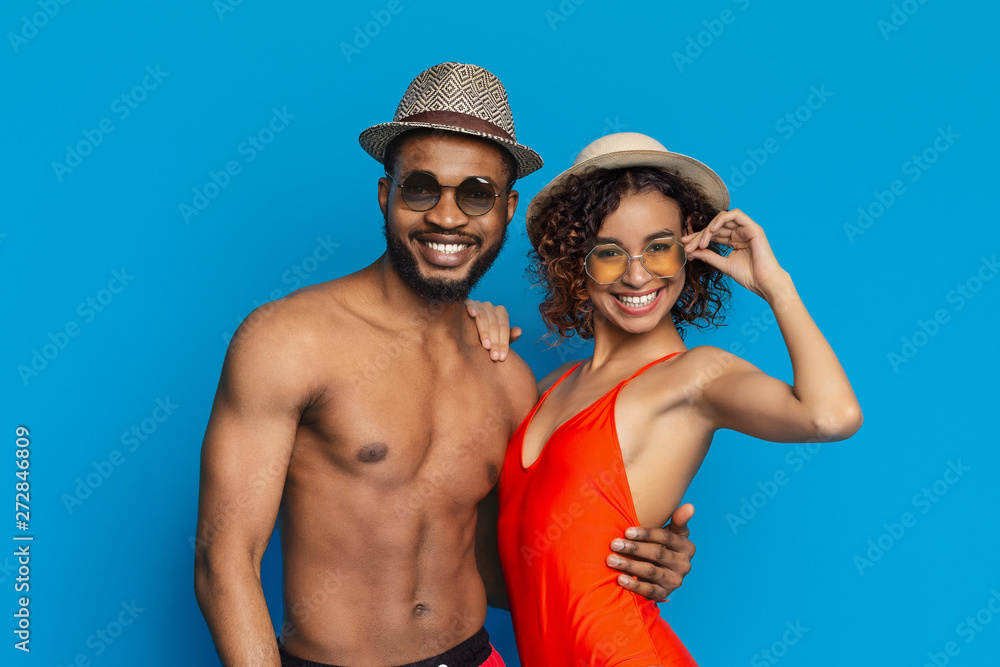 Cheerful millennial african american man and woman hugging Cheerful millennial african american man and woman hugging