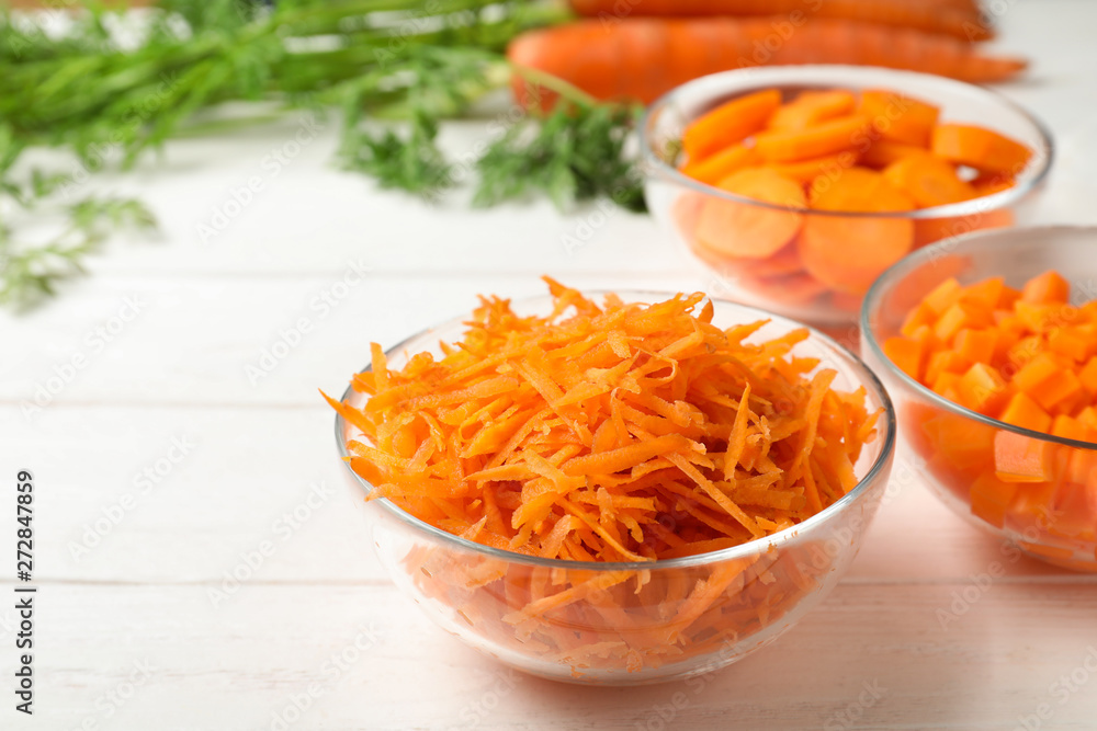 Bowls of differently cut carrots on white background Bowls of differently cut carrots on white background