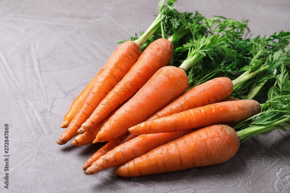 Bunch of fresh carrots on stone background Bunch of fresh carrots on stone background