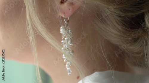 Blonde girl with earrings in her ear photo