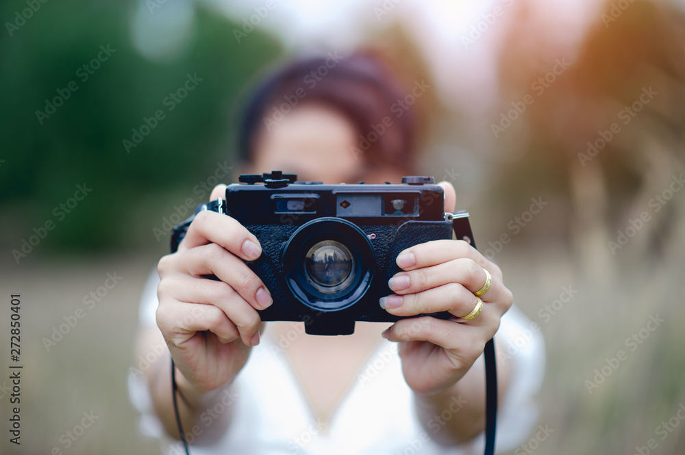 Hand and camera of the photographer Holding and carrying the camera to take pictures Hand and camera of the photographer Holding and carrying the camera to take pictures