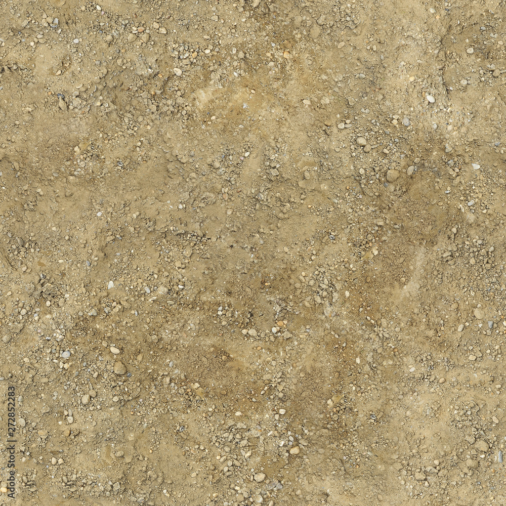 The soil underfoot is yellow with irregularities and pebbles.Texture or background. The soil underfoot is yellow with irregularities and pebbles.Texture or background.