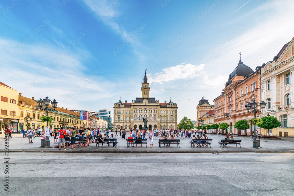 Novi Sad, Serbia June 11, 2019:  Freedom Square (serbian: Trg slobode) is the main square in Novi Sad. The photo shows County government office (City house) and monument of Svetozar Miletic.
