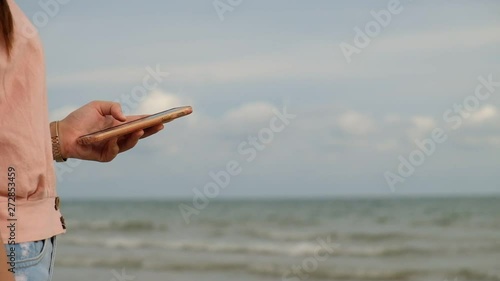 Close up, Woman use mobile phone at the beach