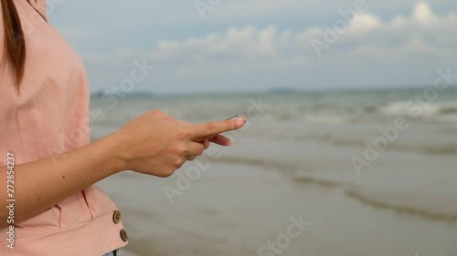 Close up, Woman use mobile phone at the beach
