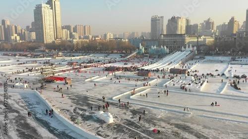 Aerial view of Winter entertainment on frozen Songhua river during annual Harbin ice and snow festival in Northern China photo