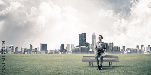 Young businessman or student studying the science and cityscape at background