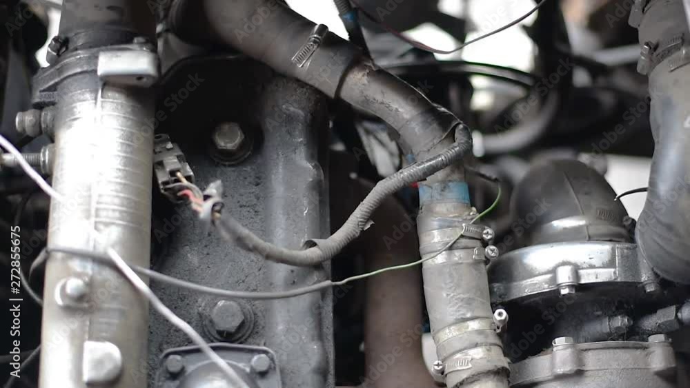 Timing belt alternator belt in motion on a running car engine. Car