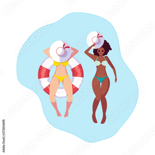 interracial girls with swimsuit and lifeguard float in water © djvstock