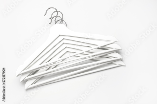 Flat lay top view White wooden hangers on white background copy space minimalism style. Sale discount store shopping concept  design empty hanger. Creative fashion beauty background. Feminine blog