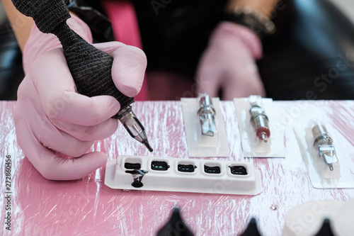 Close up of tattoo master tools. Needles, inks, petroleum jelly and disinfectant liquid. photo