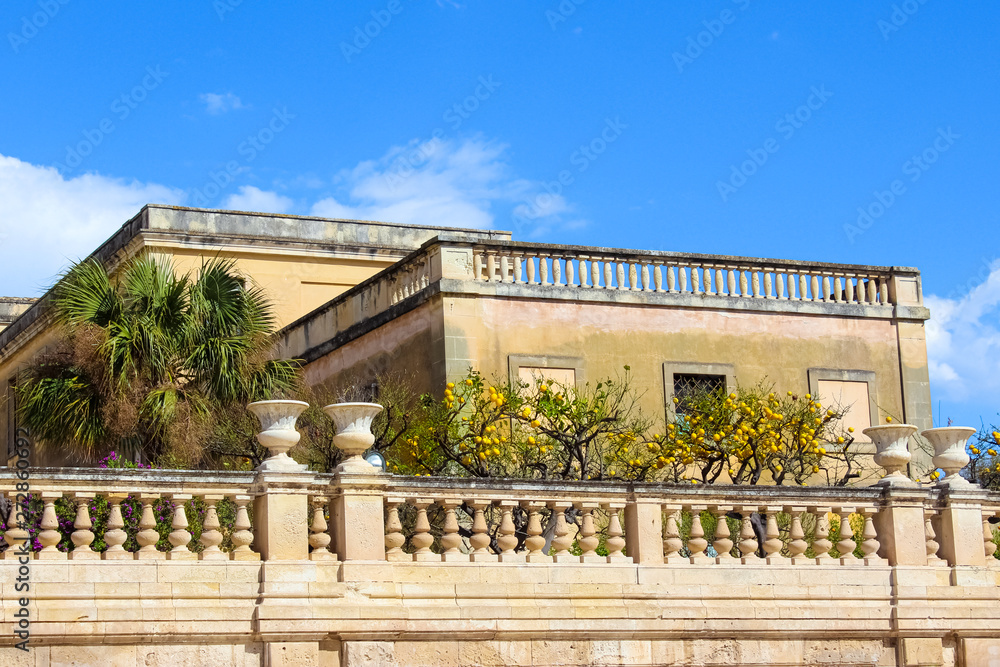 Lemon trees on historical balcony on Piazza Duomo Square in Syracuse, Sicily, Italy. The main square is located on famous Ortigia Island. Popular tourist attraction