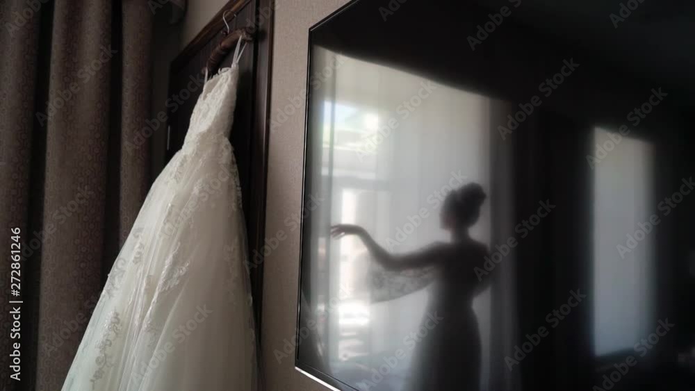 Bride and wedding dress in bedroom Bride and wedding dress in bedroom