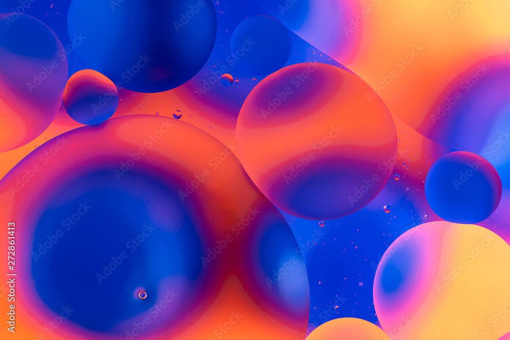 Fototapeta oily drops in water with colorful background, close-up