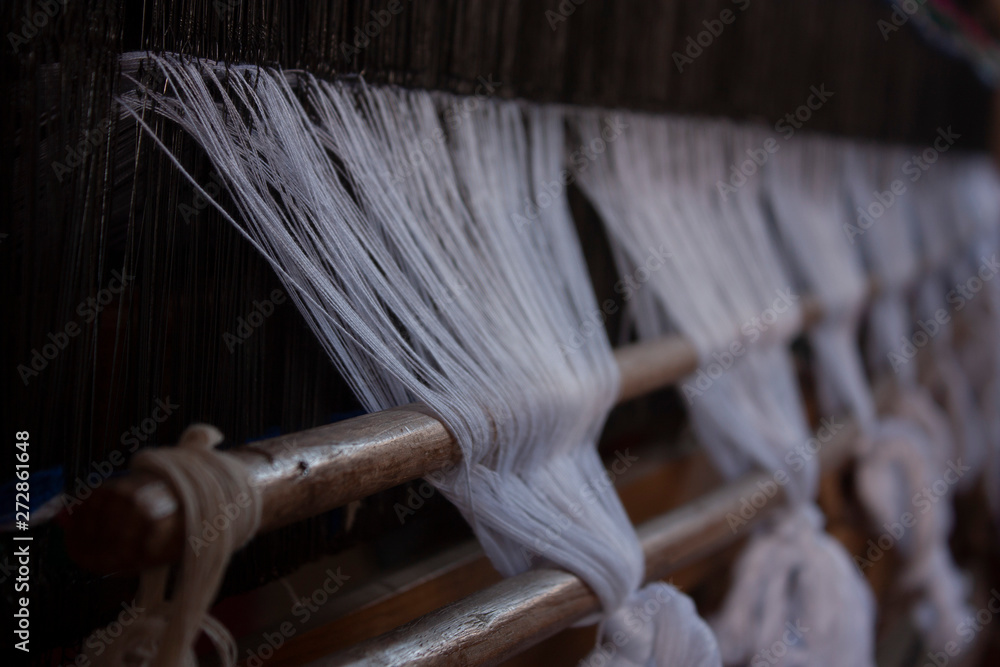  Yarns for weaving white garments mounted on a weaving machine in Mexico