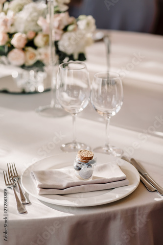 Wedding in the style vintage. Decoration of the table with flowers and cutlery. Composition from flowers. Elegant dining table in peach-purple color. Indoors wedding reception venue with festive decor
