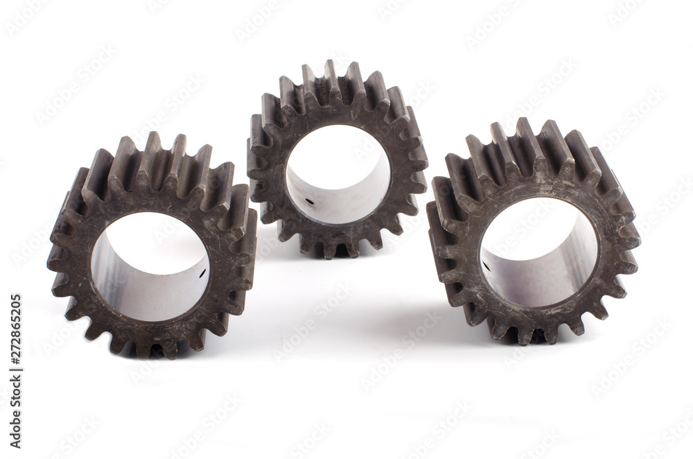 Small group of gears with their teeth engaged on a white background Small group of gears with their teeth engaged on a white background