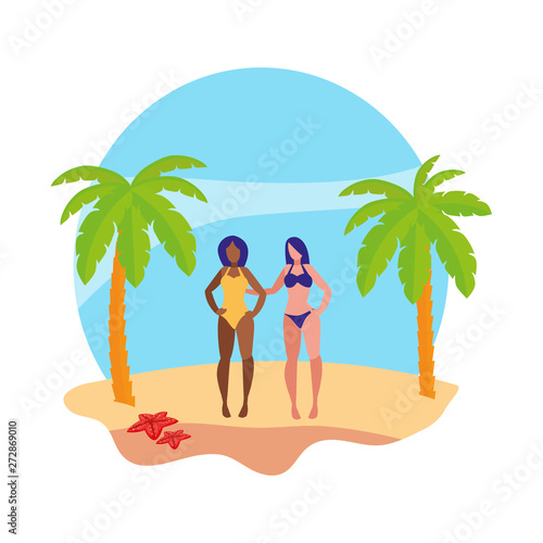 young interracial girls couple on the beach summer scene