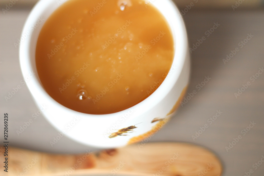 White bowl of honey. Wood table. Rustic style White bowl of honey. Wood table. Rustic style