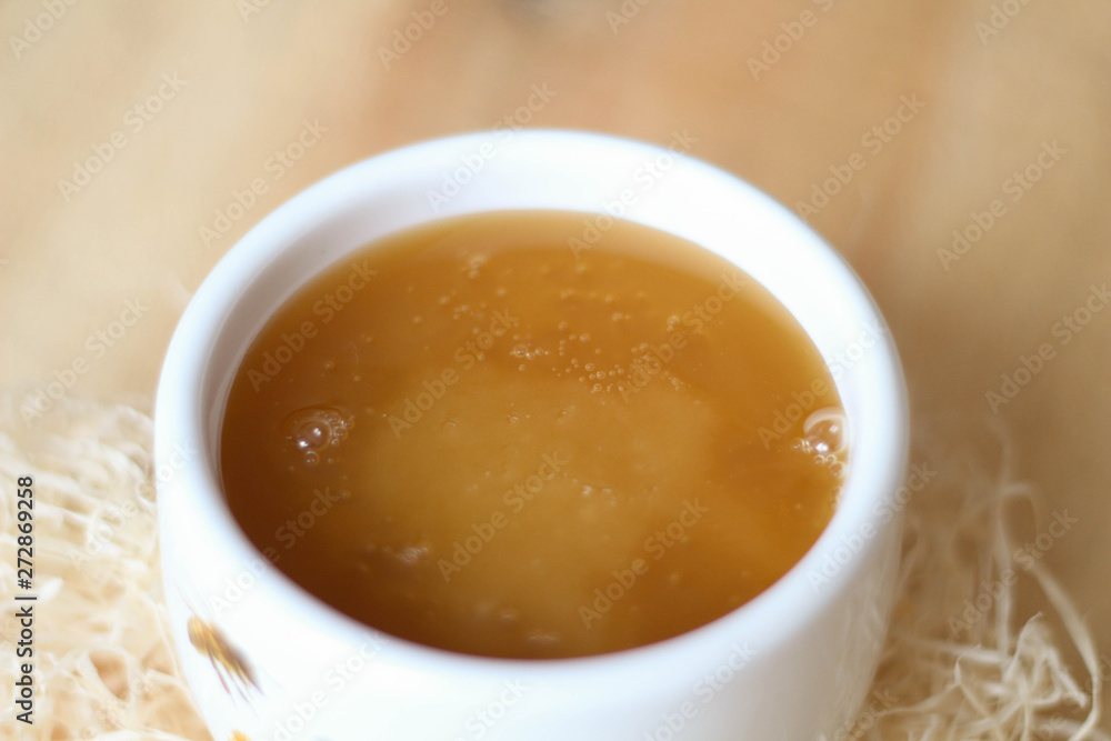 White bowl of honey. Wood table. Rustic style White bowl of honey. Wood table. Rustic style