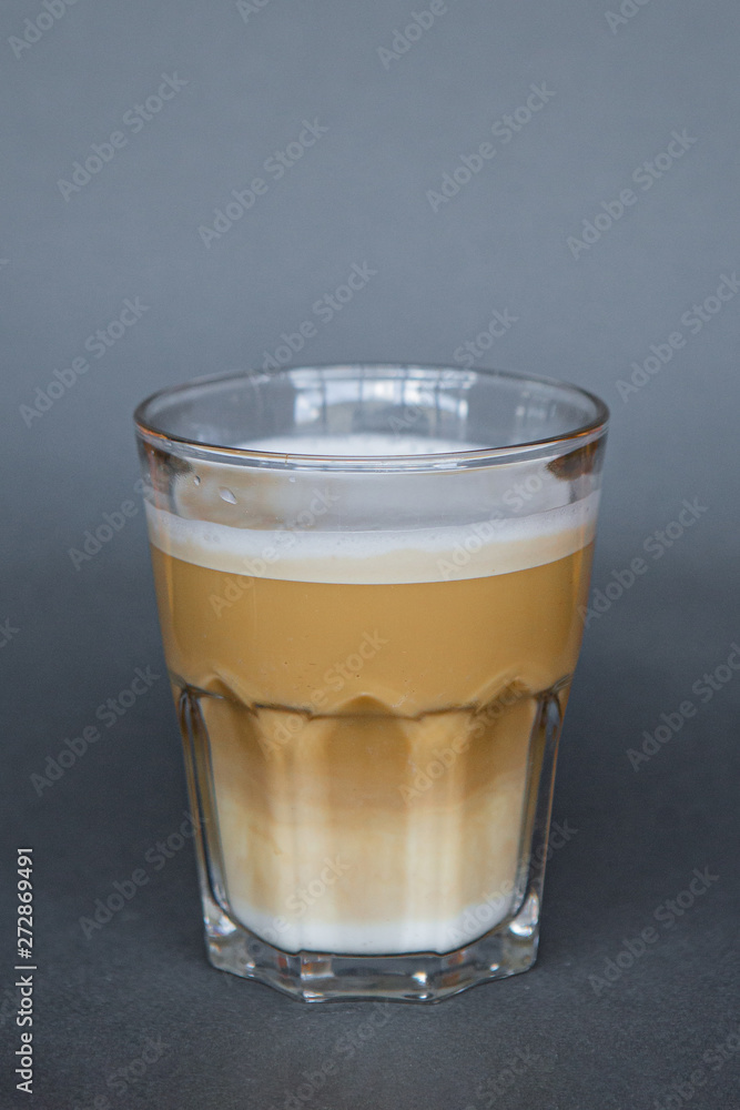 large transparent glass filled with cold summer drink coffee with milk photographed on the isolated gray background picture for the menu large transparent glass filled with cold summer drink coffee with milk photographed on the isolated gray background picture for the menu