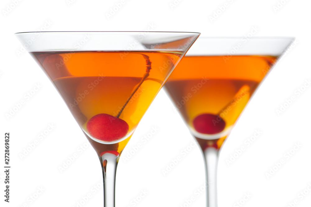 Manhattan drinks with red cherry on white Manhattan drinks with red cherry on white