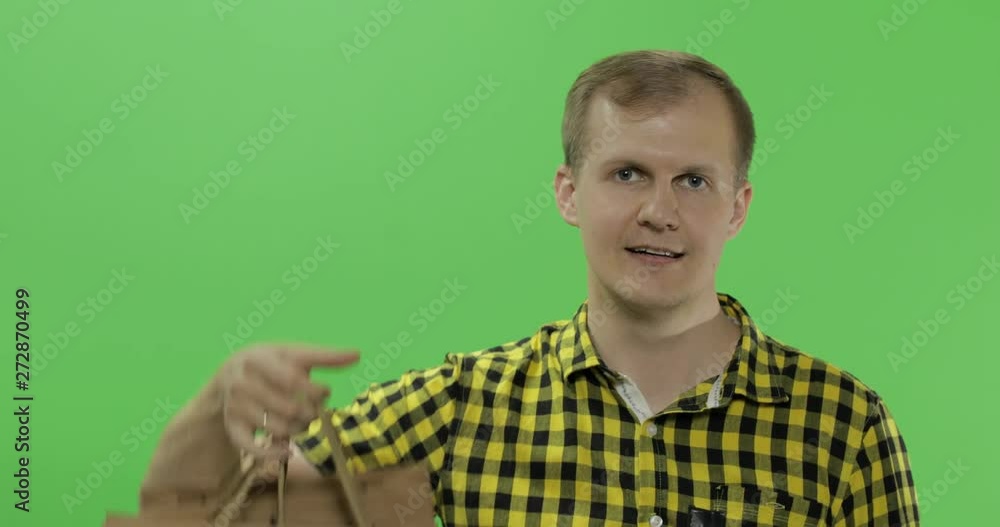 Young man on green screen chroma key background with shopping bags Young man on green screen chroma key background with shopping bags