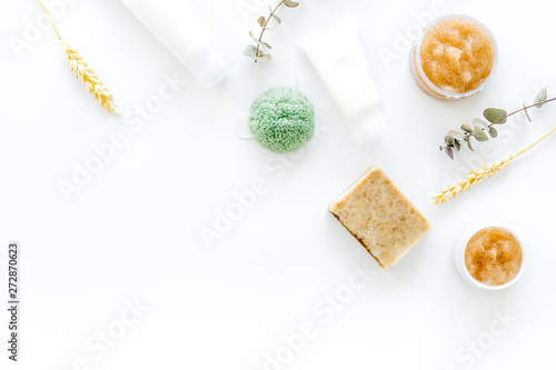 Cosmetics with natural herbal and wheat ingredients on white background top view copyspace