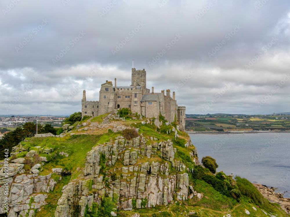 Aerial view St Michael's Mount is a small tidal island in Mount's Bay, Cornwall, England, United Kingdom. Castle and chapel on the top of the mount. 