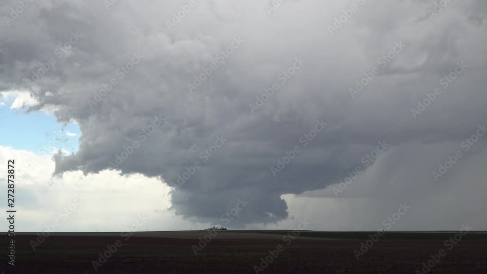 Severe thunderstorm over farm house as it tries to form a tornado in the Colorado plains as clouds spin in the sky. Severe thunderstorm over farm house as it tries to form a tornado in the Colorado plains as clouds spin in the sky.