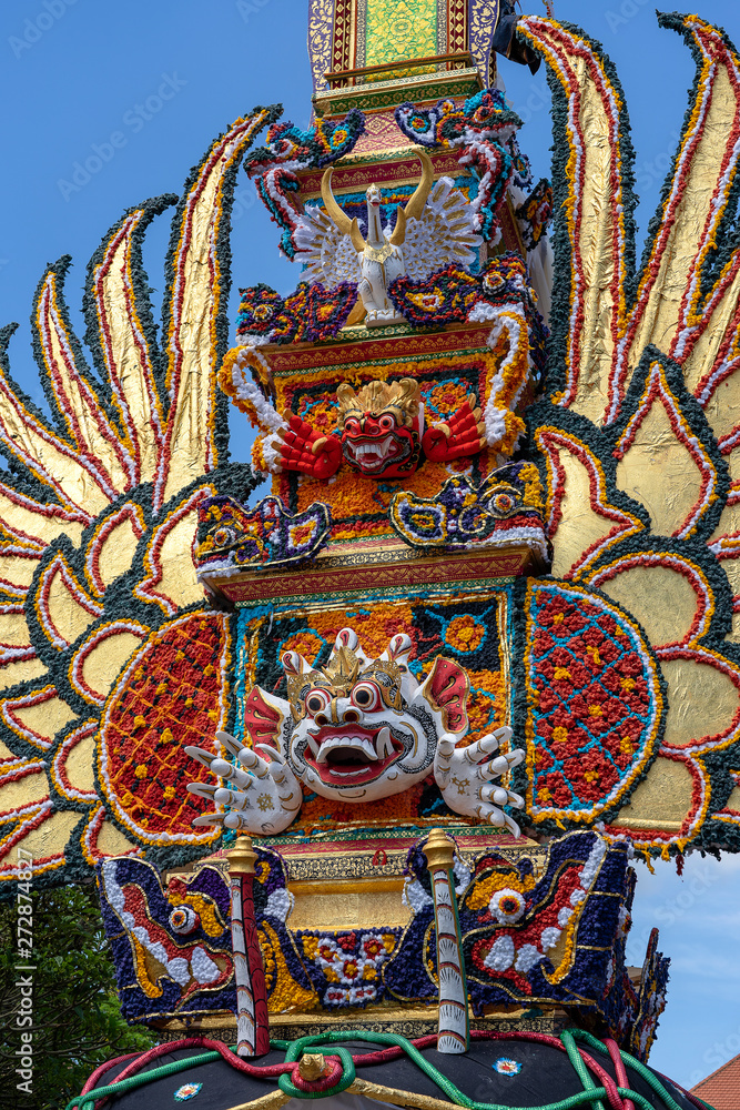 Fototapeta premium Bade cremation tower with traditional balinese sculptures of demons and flowers on central street in Ubud, Island Bali, Indonesia . Prepared for an upcoming cremation ceremony
