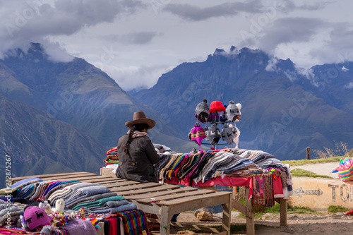 Peruvian women selling colorful hats and scarfs on the scenic and popular viewpoint. photo