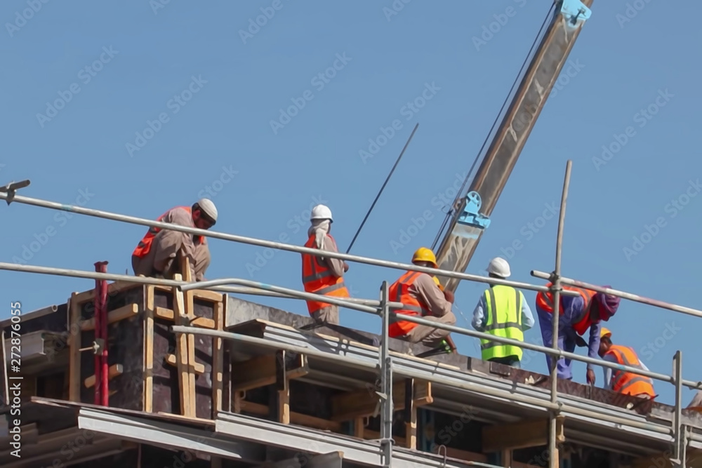 Naklejka premium Blur background, no focusing -Abstract image for the background. Construction site workers.