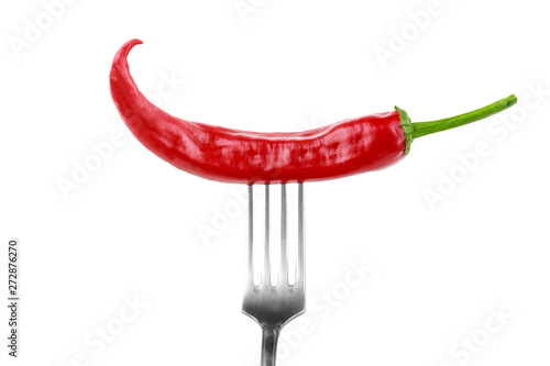 one hot red jalapeno pepper on fork on white background © Sergey