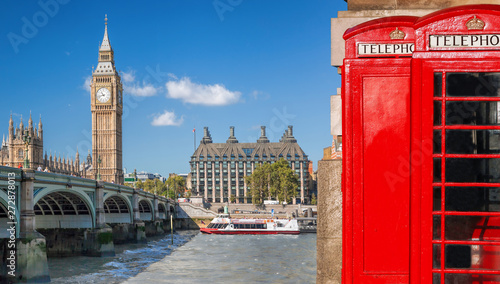 London symbols, Big Ben and Red Phone Booths with boat on river in England, UK