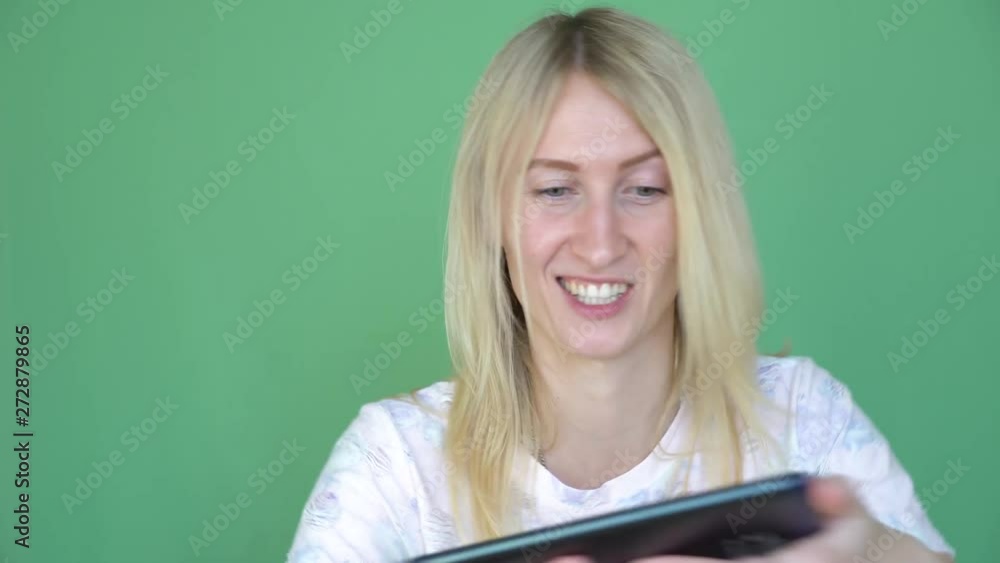 Funny woman playing game on digital tablet. Chroma Key background. modern technology concept. Funny woman playing game on digital tablet. Chroma Key background. modern technology concept.