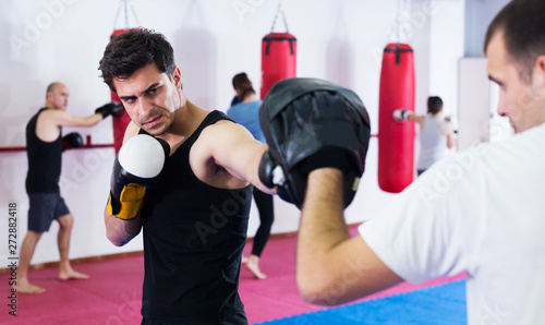 Sportsmen competing in boxing gloves © JackF