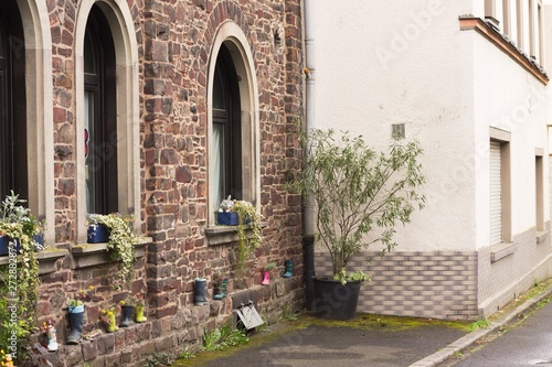 Colored garden boots in front of a brick house  Moselkern  Germany  Europe 