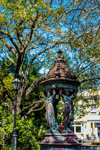 Beautiful Tree and Statue by the Center of Latrobe Park by French Market in New Orleans, Louisiana, USA