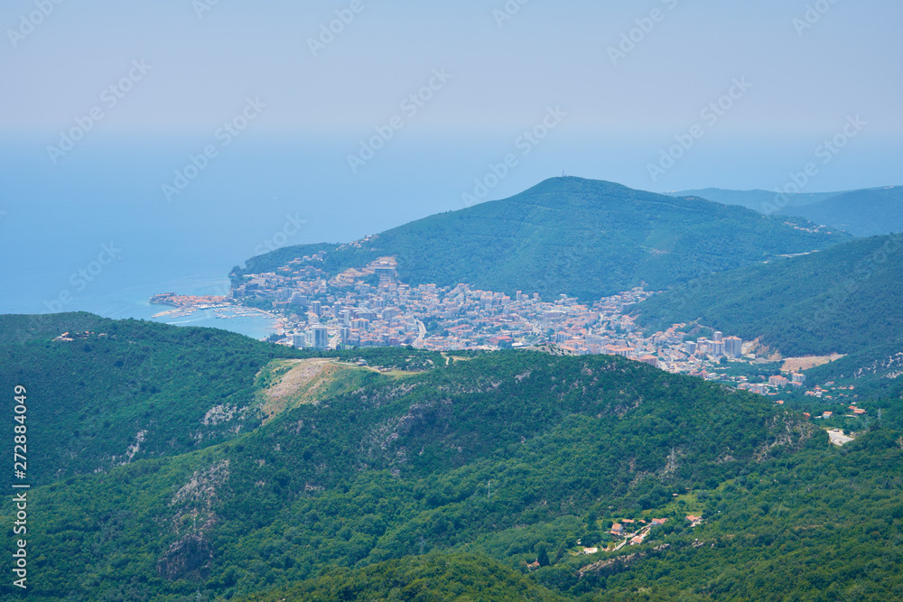 view of the city on the seashore, on the water traces of yachts, blue sea on a clear day.