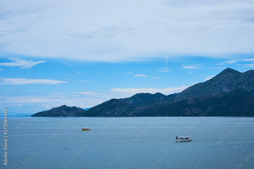 pleasure boats in the open sea in the afternoon against the backdrop of the mountains.