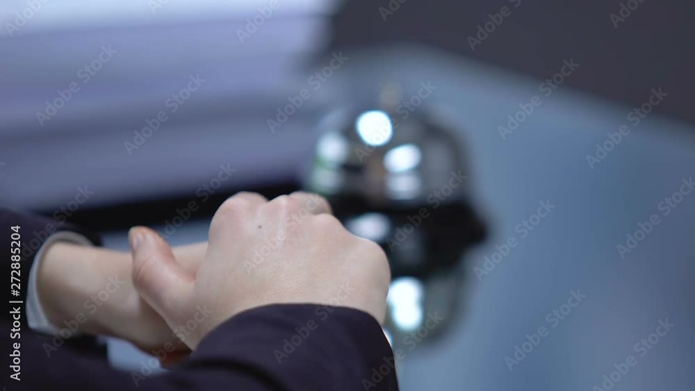 Woman client pushing reception bell and waiting for administrator of hotel Woman client pushing reception bell and waiting for administrator of hotel