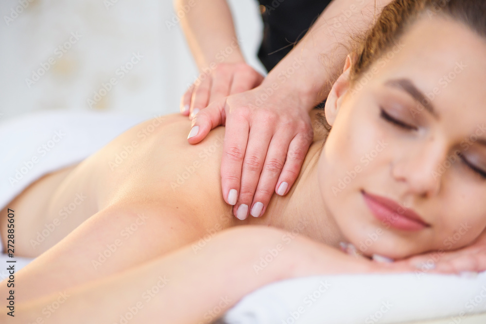 Handsome relaxing woman during massage in spa salon. Handsome relaxing woman during massage in spa salon.