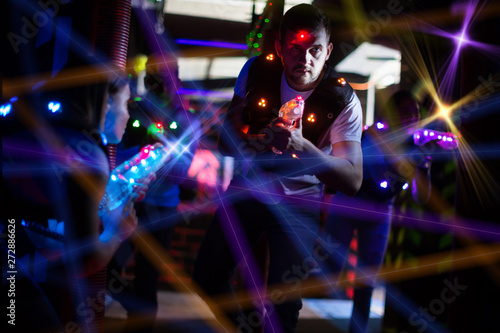 Guy in colored beams during laser tag game © JackF