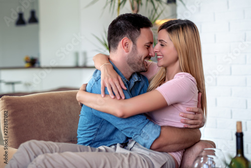 Happy couple having romantic moments at home