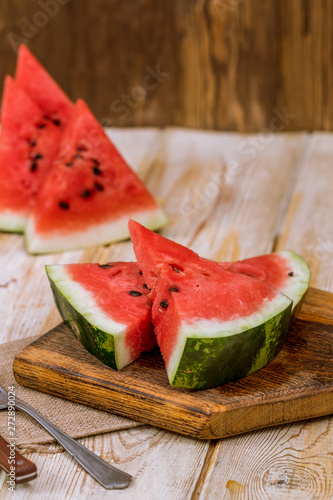 Pieces of watermelon on a wooden background