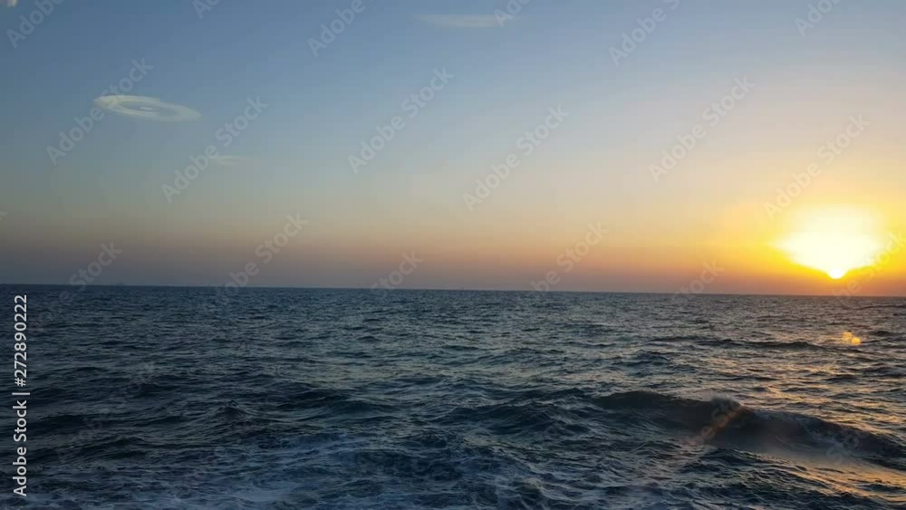 View of the ocean and sunset. Sunset over blue ocean waves. Blue ocean and sunset on the horizon. View of the ocean and sunset. Sunset over blue ocean waves. Blue ocean and sunset on the horizon.